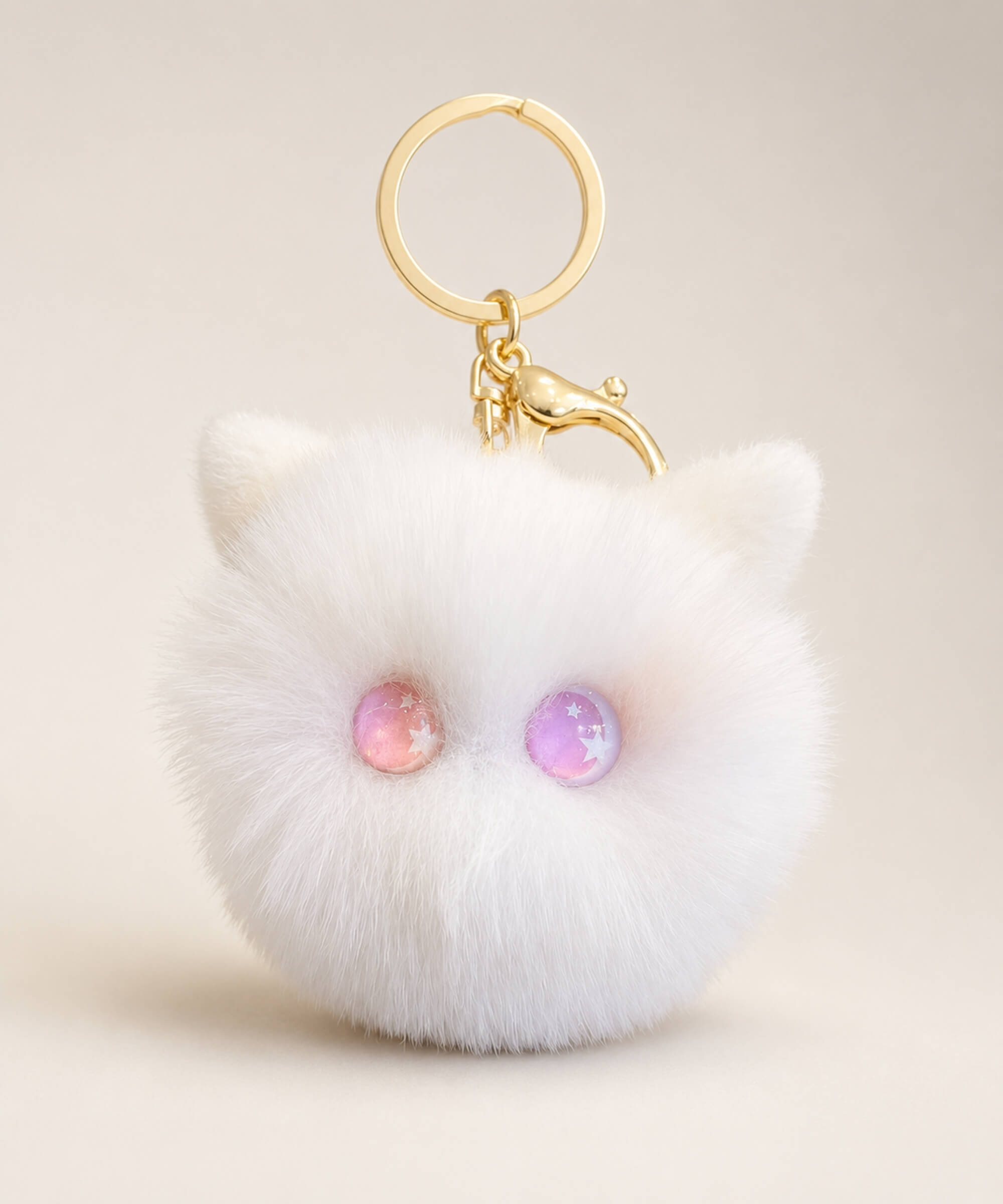 Pink eye cat plush keychain with white fluffy body, pastel pink and purple star eyes and gold hardware